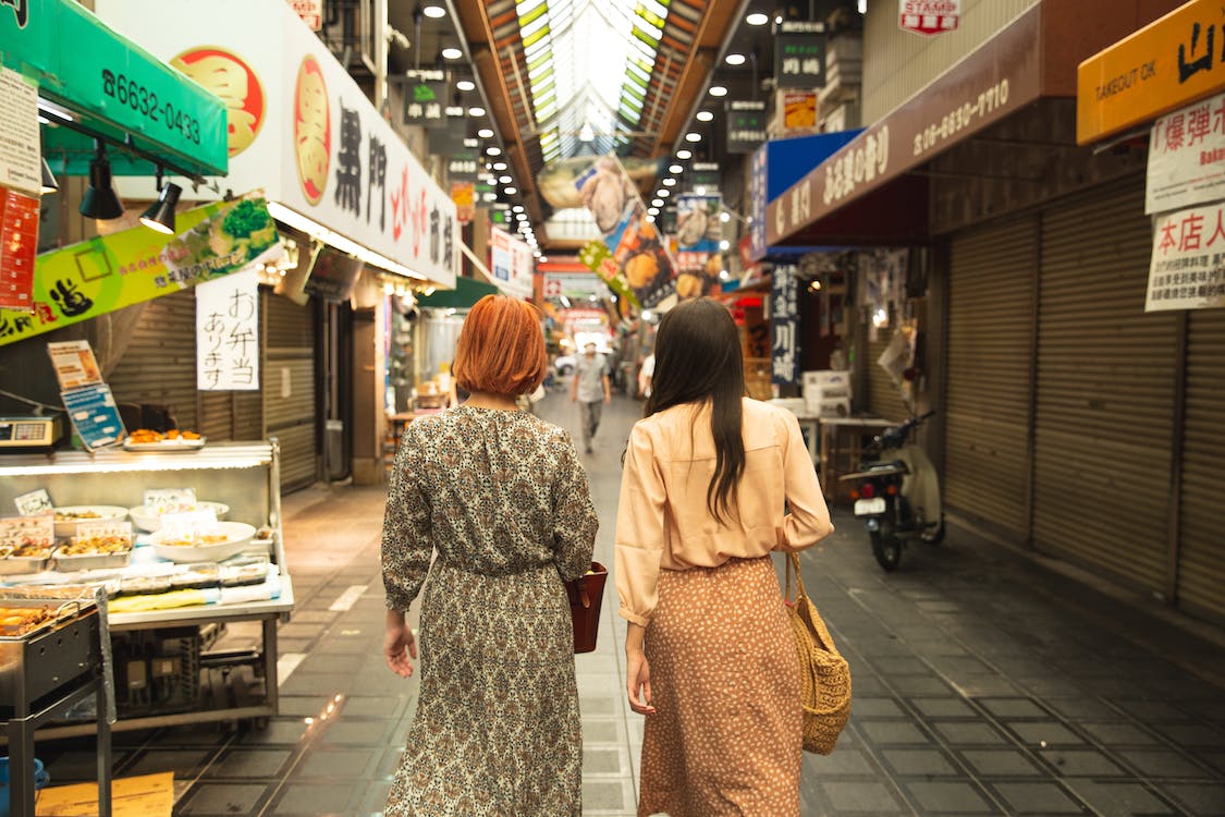 Positive japanese woman freelancer working from home, using