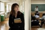 Assistant Language Teacher reflecting in a Japanese school corridor