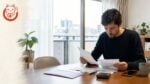 Foreign resident in Japan reviewing a resident tax bill and payment documents at home